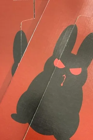 Evil bunny shipping box, red background with shadow of evil bunny on the front.